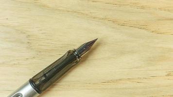 silver pen on wood table for business  content. photo