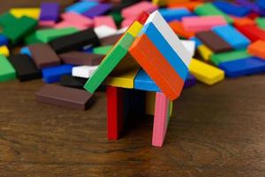 The domino multi color build home on wood table image. photo