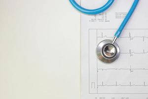 Blue stethoscopes and  Electrocardiography  chart close up image. photo