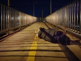 Homeless sleep on overpass bridge night time. photo