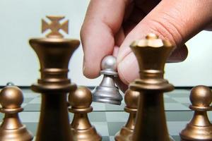 gold and silver chess on board close up image abstract Background. photo