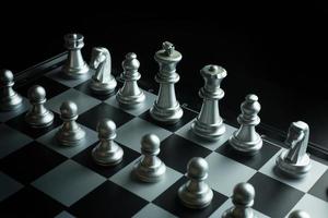 gold and silver chess on board close up image abstract Background. photo