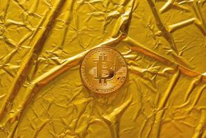 The Bitcoin cryptocurrency in gold texture  image background. photo