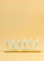 white  figure miniature on orange pastel for business content. photo