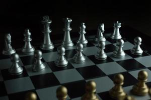 gold and silver chess on board close up image abstract Background. photo