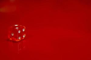 Two Red dice on bright red glossy background. photo