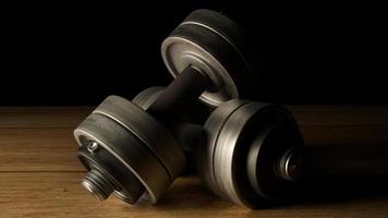 dumbbells  wood floor dark tone 3d rendering for fitnesses content. photo