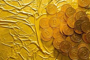 The Bitcoin cryptocurrency in gold texture  image background. photo