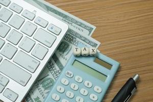 Tax wooden cubic on work table for business content. photo