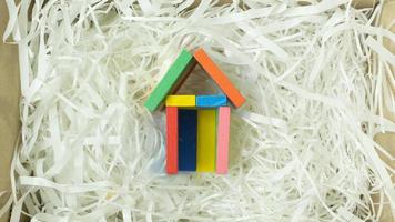 Toy home on Cushioning paper in box for home business content. photo