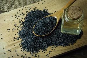 black Sesame seeds  on a old wooden table. photo