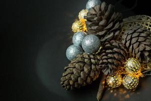 The christmas ball and Pine cones  on black  background. photo