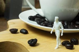 The white miniature and coffee beans vintage mood and tone photo