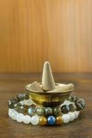 Incense Cone in a stand with the feather for background. photo