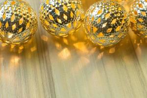 The gold Christmas ball  on  white  wood  table background. photo