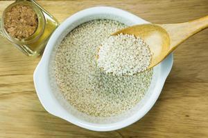 white Sesame seeds  on a old wooden table. photo