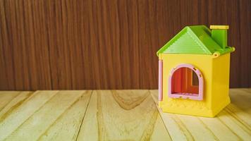 The home toy on wood table for property and building content. photo