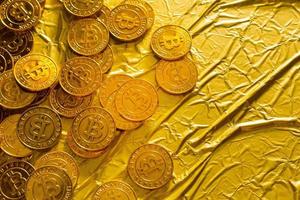 The Bitcoin cryptocurrency in gold texture  image background. photo