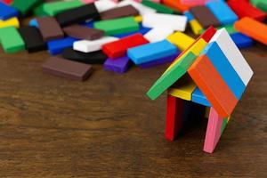 The domino multi color build home on wood table image. photo