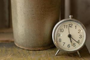 White vintage clock alarm  near window light. photo