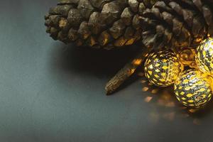 The christmas ball and Pine cones  on black  background. photo