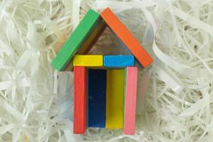 Toy home on Cushioning paper in box for home business content. photo