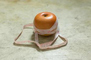 Apple and measuring tape image  for diet content. photo