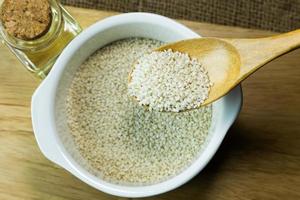 white Sesame seeds  on a old wooden table. photo