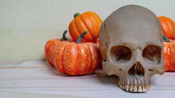 pumpkin jack doll and skull on wood table for halloween content. photo