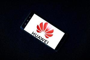 Huawei logo Logo of the huawei mobile company on the Huawei P30 Pro mobile phone. Selective focus. Warsaw, Poland. 10.01.2022 photo