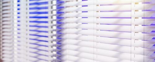 Panoramic view of White Venetian blinds with sunlight. Window blinds. 3d rendering. photo