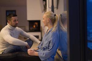 happy couple in front of fireplace photo