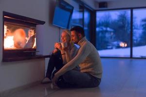 happy couple in front of fireplace photo