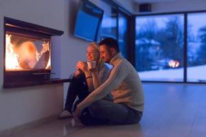 happy couple in front of fireplace photo
