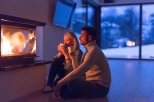 happy couple in front of fireplace photo