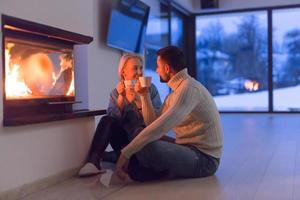 happy couple in front of fireplace photo