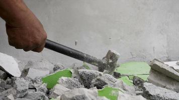 Worker using hammer hit concrete for break it to be small fractal construction concept video