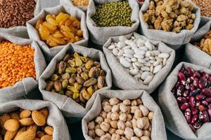 Various types of dried fruit and cereals at farmers market. Mung bean, almond, mulberry, garbanzo, raisins. Close up shot photo