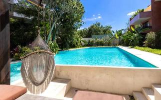 Mexico, Tulum upscale hotel patio with jungle views and hammock photo