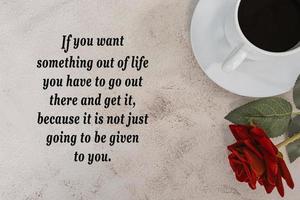 Motivational and inspirational quote with coffee and red rose on marble desk. photo