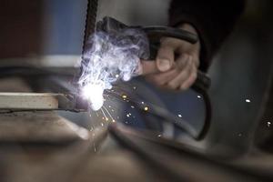 Welding and bright sparks. Hard and dangerous job. photo