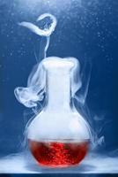 Chemical reaction in volumetric flask glass in labolatory. The concept of scientific experiments. photo