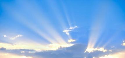 Horizontal shot of background of sun rays over clouds. photo