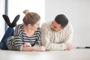 Young Couple using digital tablet on cold winter day photo