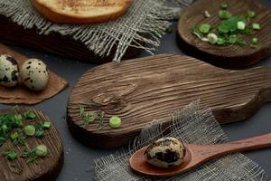 Rustic photo. On a wooden cutting Board, cut green onions and quail egg in a wooden spoon. photo