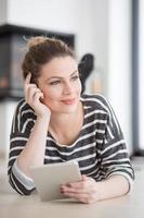 woman using tablet computer in front of fireplace photo