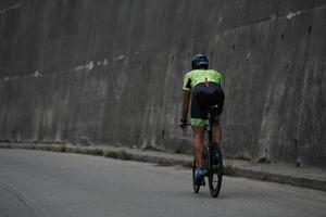 triathlon athlete riding a bike on morning training photo