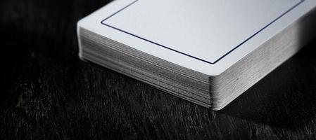 A deck of playing cards close up in soft focus on a black background. photo