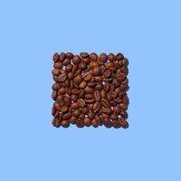 Coffee beans in the shape of a square isolated on a blue background. photo