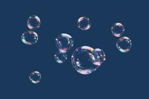 Flying soap bubbles isolated on blue background. Abstract background. photo